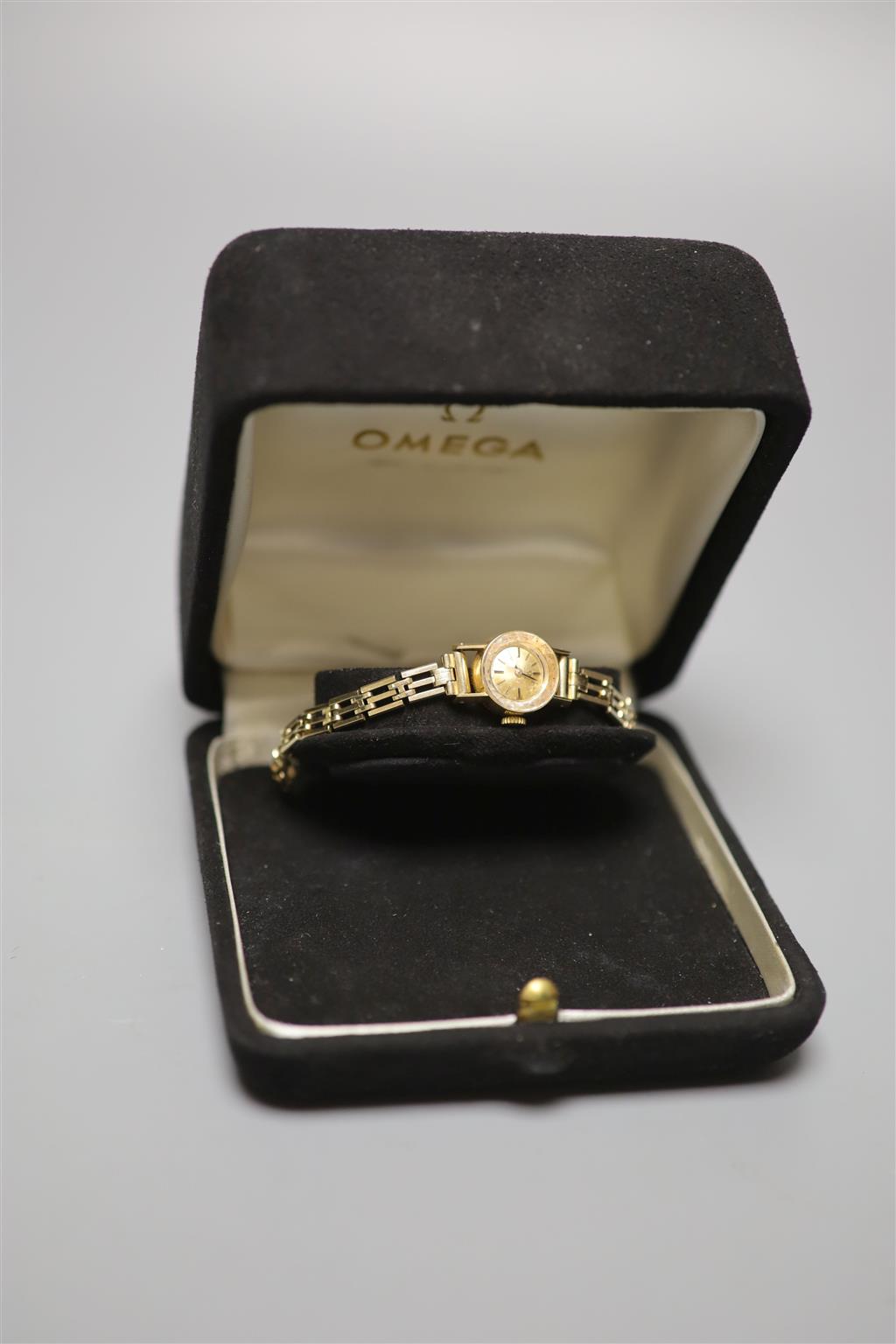 A ladys 1960s 18ct gold Omega manual wind wrist watch, on a gold plated bracelet with box and guarantee,